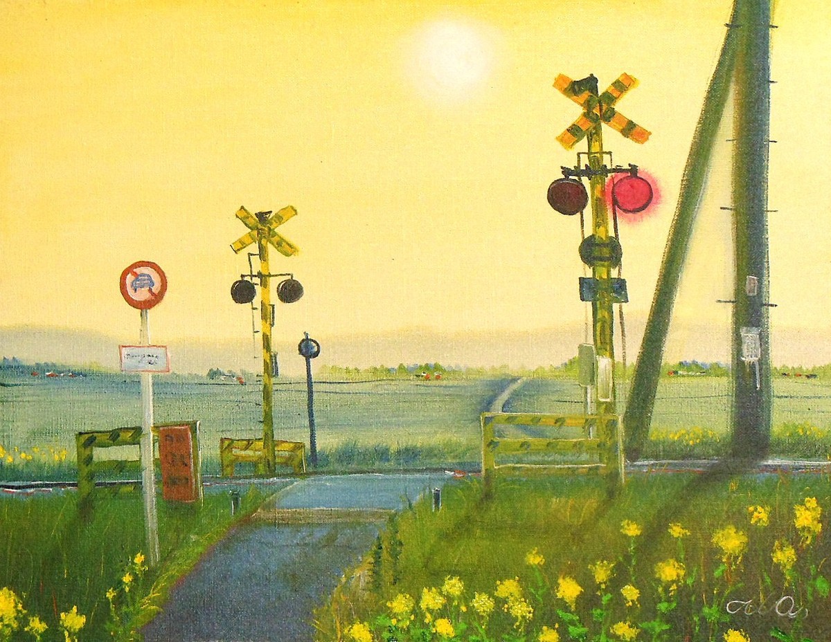 黄昏の菜の花咲く、踏切風景