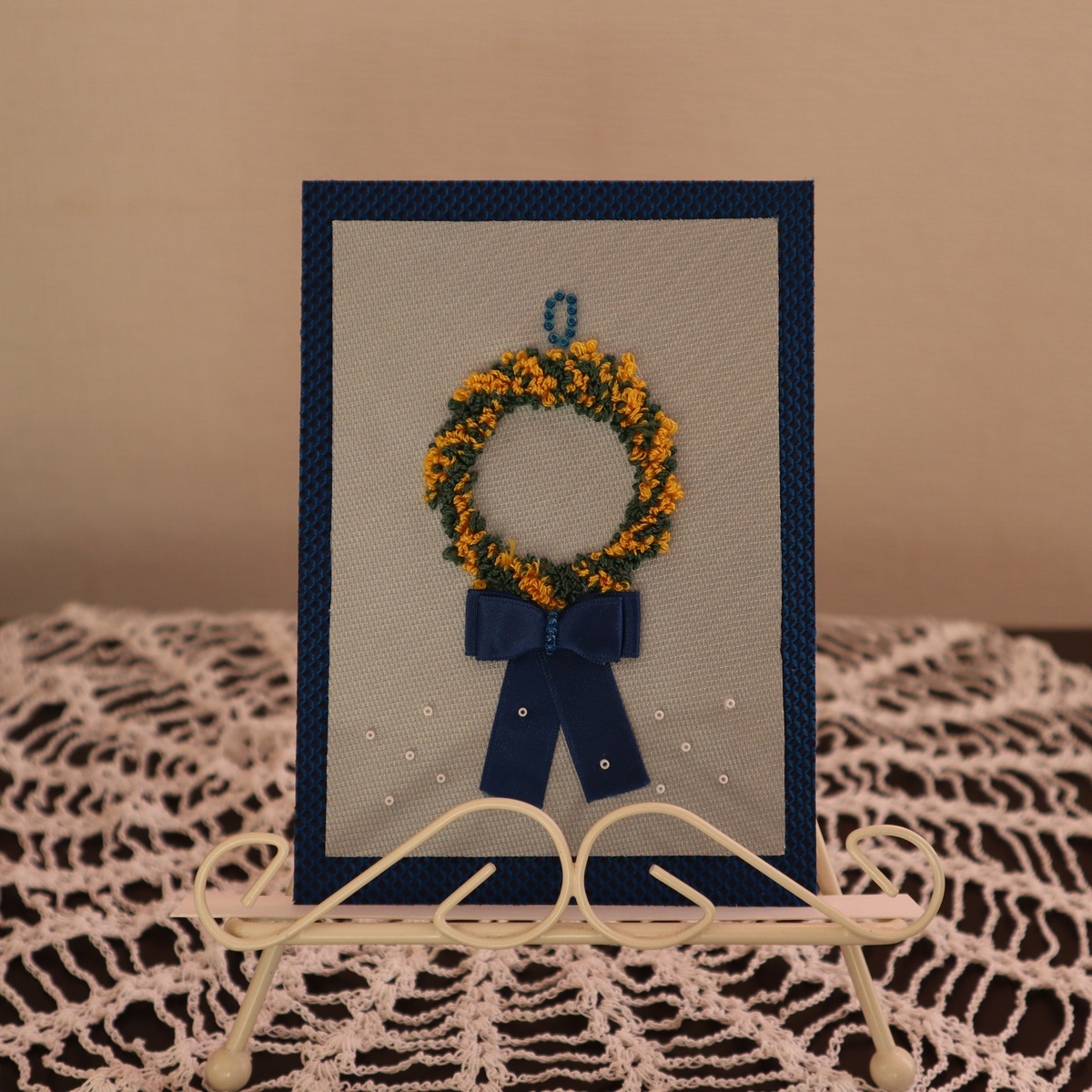 白いワイヤー素材のイーゼルに飾った時の様子です。